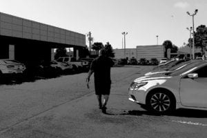 Steve Gonzalez walks a car lot