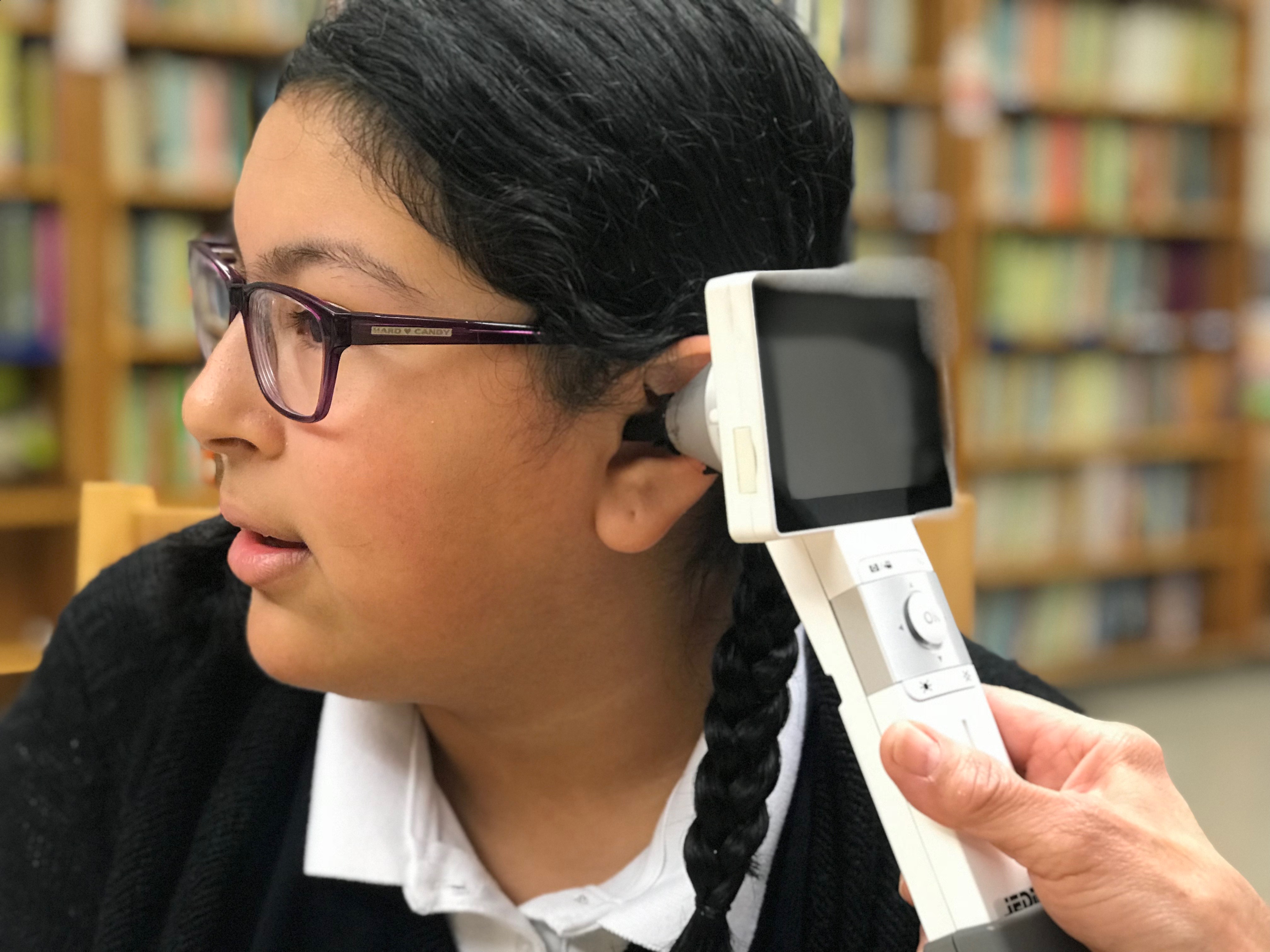 St. Pius V Catholic School student being checked out with the help of a telemedecine device