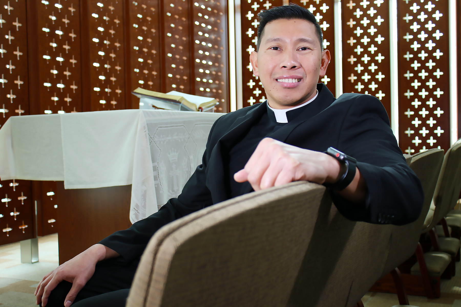 Father Ian Balinomo, FLP, at the front pew of the at the Chapel in the W.T. & Louise J. Moran Center