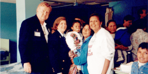 Dr. Ernest Cronin, Candy Cronin, and Dr. Yvonne Cormier with mother and child post-operation